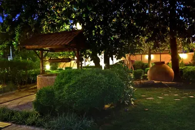 a garden with a gazebo and a bush at Anita House in Perushtitsa