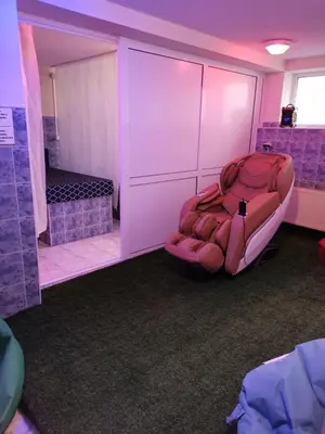 a room with a chair in a room with purple lighting at Hotel Elit in Devin