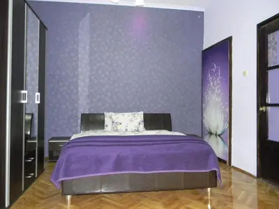 a bedroom with a purple bed with a purple wall at Top Place in Downtown in Sofia
