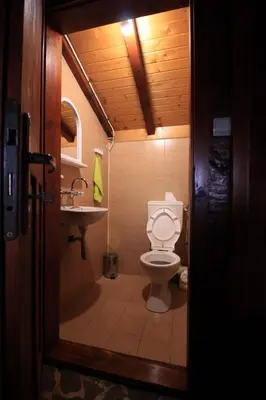a small bathroom with a toilet and a sink at Belcheva kashta in Banya