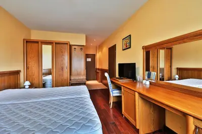 a hotel room with a bed and a desk at Bellevue Residence Apartments in Bansko