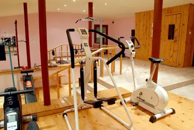 a gym with two exercise bikes on a wooden floor at Hotel Prespa in Pamporovo