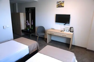 a hotel room with a desk and a television at Hotel Ihtiman in Ikhtiman