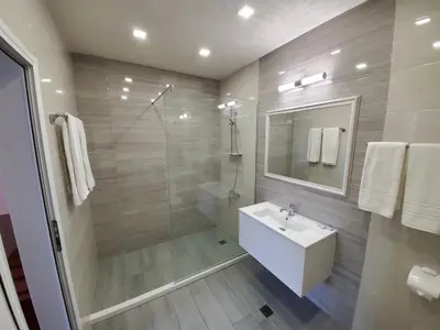 a bathroom with a white sink and a shower at Hotel Galant in Sofia
