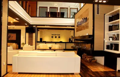 a living room with white furniture in a building at Saint George Palace Aparthotel in Bansko