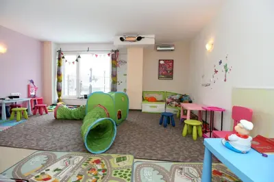 a childs play room with colorful chairs and tables at Saint George Palace Aparthotel in Bansko