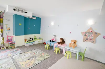 a childs room with two tables and a playroom with toys at Saint George Palace Aparthotel in Bansko