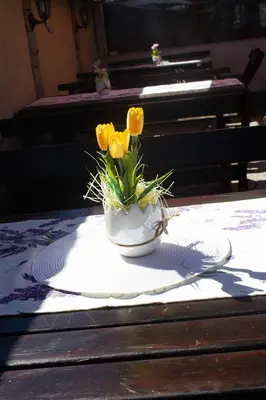 a vase with yellow flowers sitting on a table at Meteor Family Hotel in Chepelare