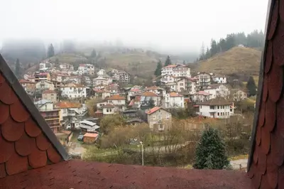 a view from a window of a town on a mountain at Meteor Family Hotel in Chepelare