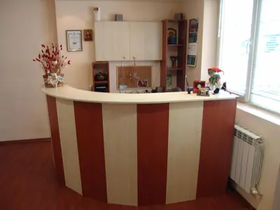 a kitchen with a striped island in the middle of a room at Zasheva Kushta Guesthouse in Bansko