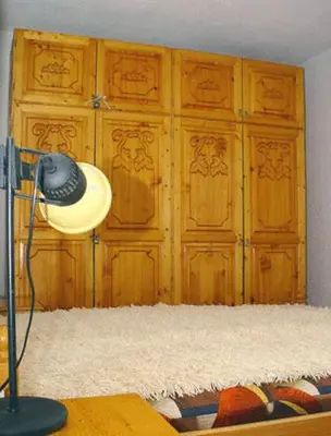 a room with a closet with a hat on a table at Damianka Guest House in Bansko