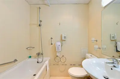 a bathroom with a tub and a toilet and a sink at Augusta SPA Hotel in Hisarya