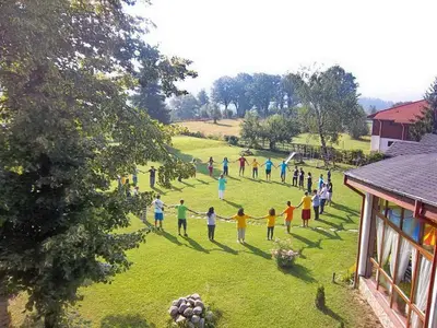 a group of people holding hands in a field at Pripetzite Hotel in Godlevo