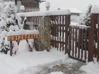 a fence covered in snow with a sign on it at Pripetzite Hotel in Godlevo