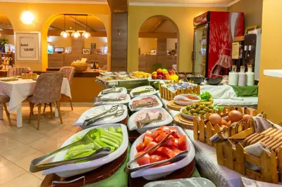 a table with plates of food on it at Grami Hotel in Bansko