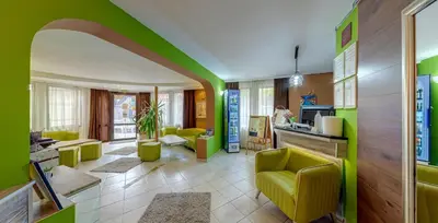 a living room with green and yellow walls at Grami Hotel in Bansko