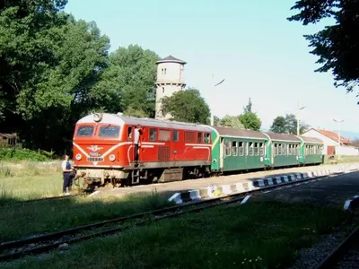a red and green train on the tracks with a lighthouse at Fortuna Apartments in Bansko