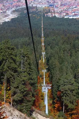 a gondola ride up a hill with a crossroads at Fortuna Apartments in Bansko