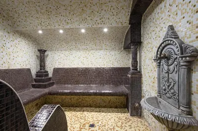 a room with a tub and a bench in a building at Hotel Bellevue - Half Board in Pamporovo