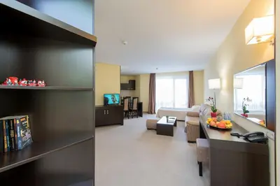 a living room with a couch and a table at Hotel Bellevue - Half Board in Pamporovo