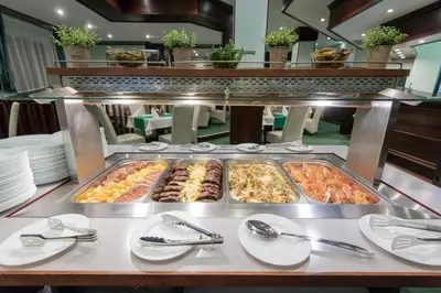 a buffet with several trays of food on a table at Hotel Bellevue - Half Board in Pamporovo