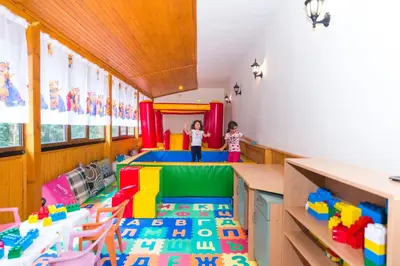 two children standing in a play room with legos at Elina Hotel in Pamporovo