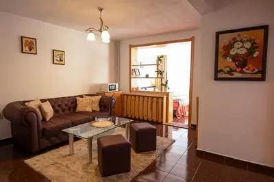 a living room with a couch and a table at Vezyuva House in Bansko