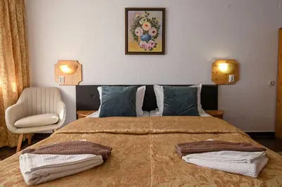 a bedroom with a bed with two towels on it at Vezyuva House in Bansko
