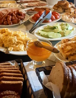 a table full of different types of food on plates at Vezyuva House in Bansko
