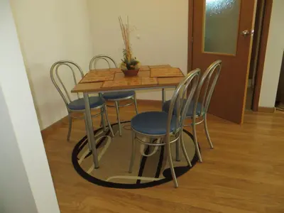 a dining room table with chairs and a wooden table at Apartment 