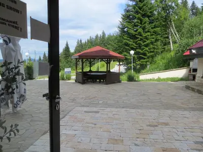 a gazebo with a bench in a park at Apartment 