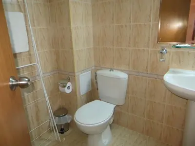 a bathroom with a toilet and a sink at Apartment 