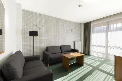 a living room with a couch and a table at Hotel Iceberg Bansko in Bansko