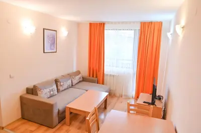 a living room with a couch and a table at Apart Hotel Orbilux in Bansko
