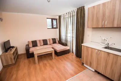 a living room with a couch and a table at Apart Hotel Orbilux in Bansko