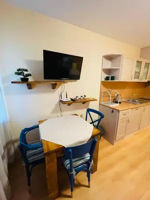 a room with a table and two chairs and a kitchen at Studio Kris Villa Park in Borovets