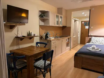 a small kitchen and dining room with a table and chairs at Studio Kris Villa Park in Borovets