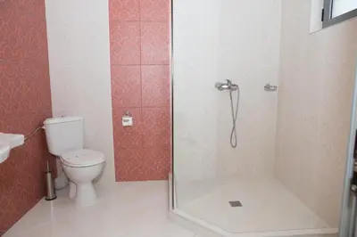 a bathroom with a shower and a toilet at Hotel Bordo in Plovdiv