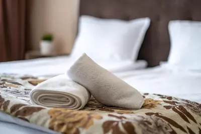 a towel sitting on top of a bed at Luxor Apartment in Velingrad