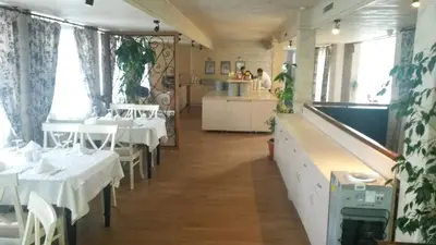 a dining room with white tables and white chairs at Paradiso Verde (Green Life) in Bansko