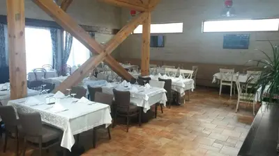 a dining room with tables and chairs with white table cloth at Paradiso Verde (Green Life) in Bansko