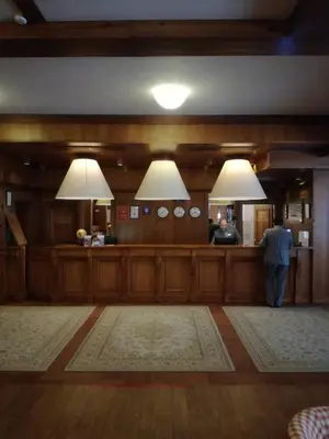 a man standing at a bar in a room at Paradiso Verde (Green Life) in Bansko