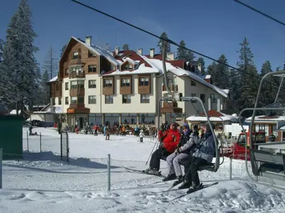 a group of people sitting on a ski lift at Ice Angels Hotel in Borovets