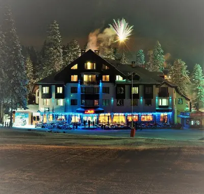 a large building with lights on in the night at Ice Angels Hotel in Borovets