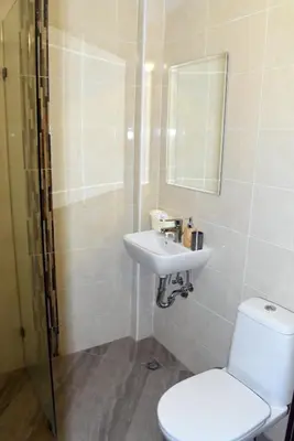 a bathroom with a toilet and a sink and a mirror at Къща Стария град in Plovdiv