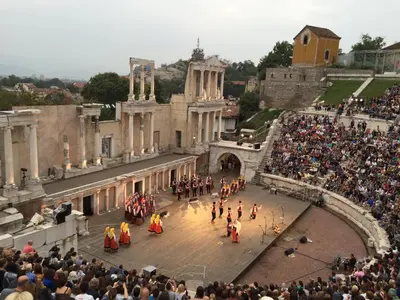 a crowd of people watching a parade in front of a building at Къща Стария град in Plovdiv