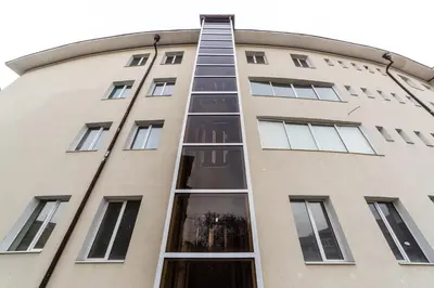 a building with a ladder on the side of it at Семеен хотел Пауталия in Kyustendil