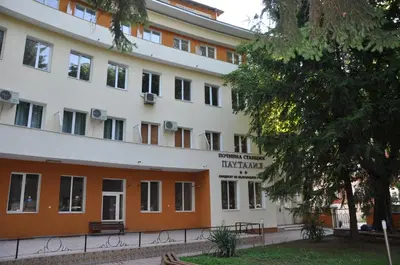a building with a tree in front of it at Семеен хотел Пауталия in Kyustendil