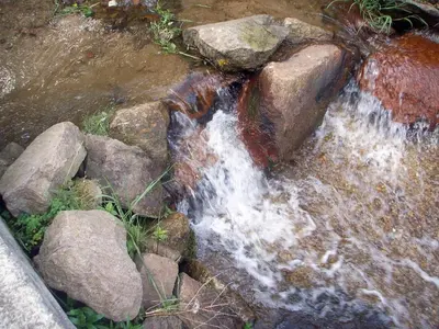 a stream of water with rocks in a river at The Lake Villa in Smolyan