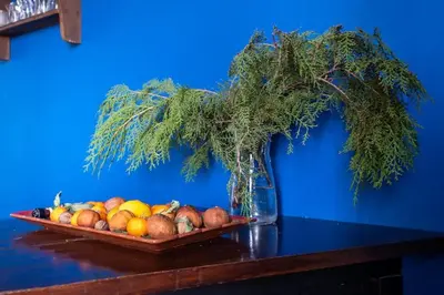 a plate of fruit sitting on a table with a vase at Cool Central Apartment in Sofia